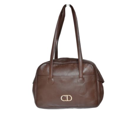 A Christian Dior vintage bag, the brown smooth leather exterior with gold tone hardware, twin handles and zip top fastening.C