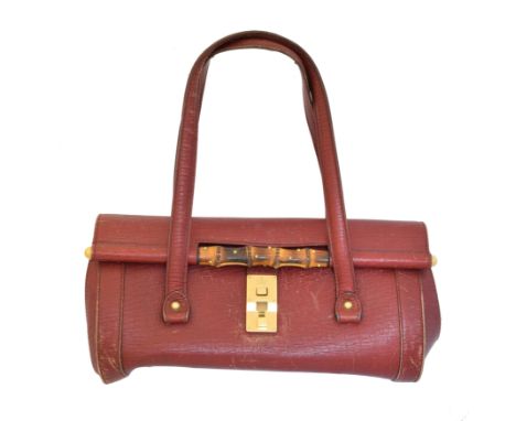 A vintage Gucci bamboo handbag, the red leather exterior with bamboo and gold tone clasp, serial no. 114993 3444.Condition re