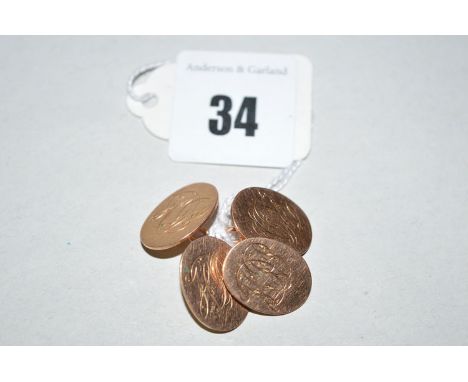 A pair of 9ct. yellow gold cufflinks, the oval plaques all engraved with monograms, 10grms gross.