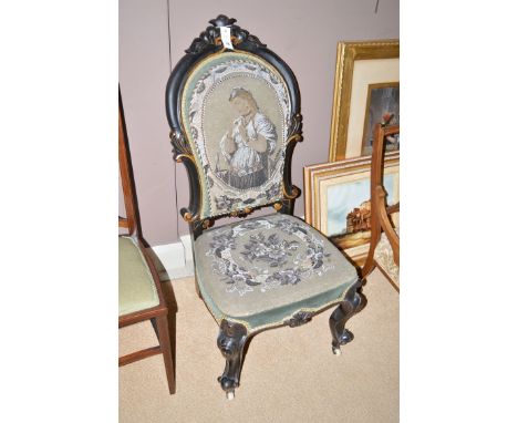 A Victorian nursing chair, the high shaped back with carved acanthus leaf decoration above a shaped seat, the seat and back u