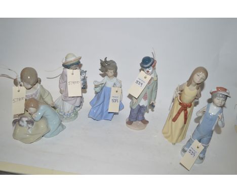 A collection of four Lladro ornaments, three modelled as children, one as a clown; a Nao ornament modelled as a young girl in