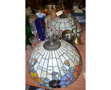 A pair of large Tiffany style circular ceiling light fittings with stylised floral design.