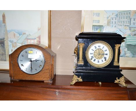 A Victorian mantel clock in architectural style black painted wooden case with decorative columns, metal lion mask handles an