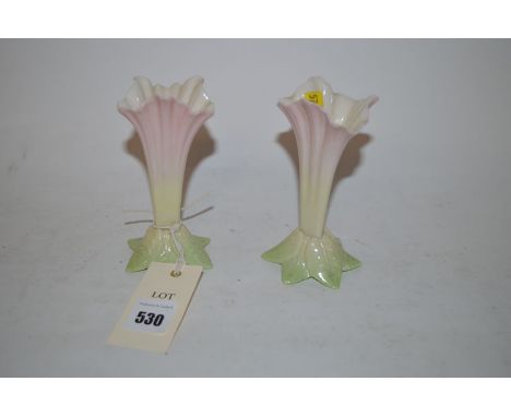 A pair of Royal Worcester spill vases in the form of pink flowers, hexagonal leaf form bases, shape 365 (one with chipped rim