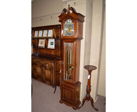 A modern grandmother clock in mahogany case, with decorative swan neck pediment above a central finial above an arched glazed