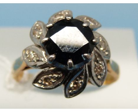 An 18ct gold ring set with a large central sapphire surrounded by diamonds in a platinum setting (size N)