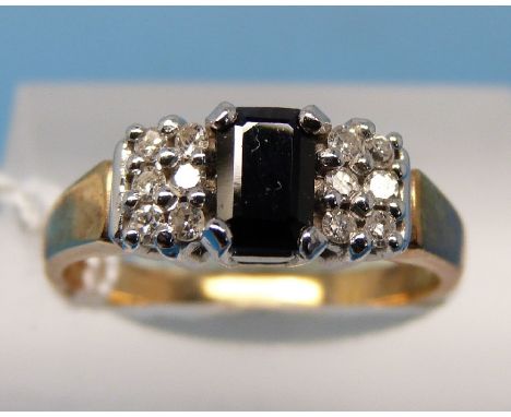 A 9ct gold ring set with an emerald cut sapphire and six diamonds to each shoulder (size N)