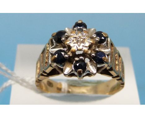 A 9ct gold ring set with a diamond surrounded by sapphires (size N)