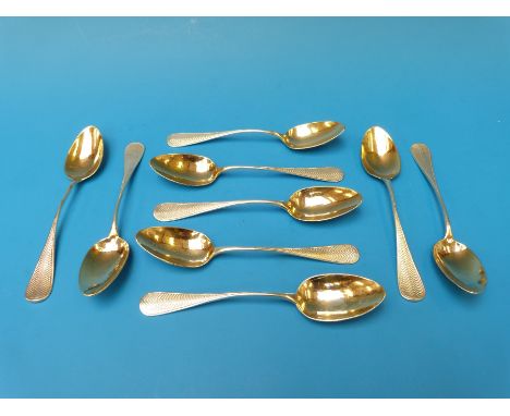 A set of nine French white metal teaspoons with gilt bowls and engine turned handles, silver marks for France, maker's mark L