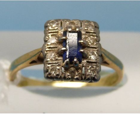 An 18ct gold ring set with an emerald cut sapphire surrounded by diamonds (size L)