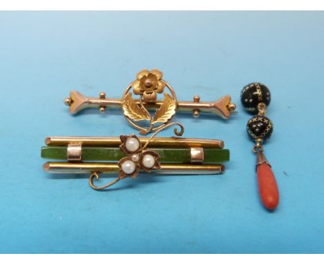 A yellow metal brooch set with a long rectangular strip of jade and four pearls arranged in a foliate design to the centre, a
