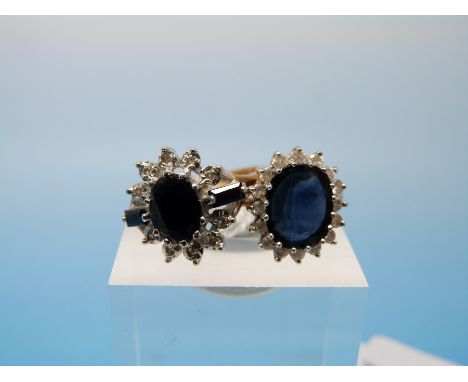 Two hallmarked 9ct gold rings each set with a central sapphire surrounded by diamonds (size K)