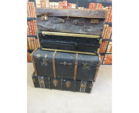 A collection of vintage luggage including a travelling robe