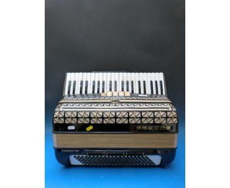 A Hohner Virtuola III 1970s 120 bass piano accordion, in smart black finish, five treble couplers and three on bass side (cas