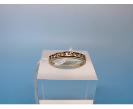 A yellow metal ring marked .375 set with clear stones (size K)