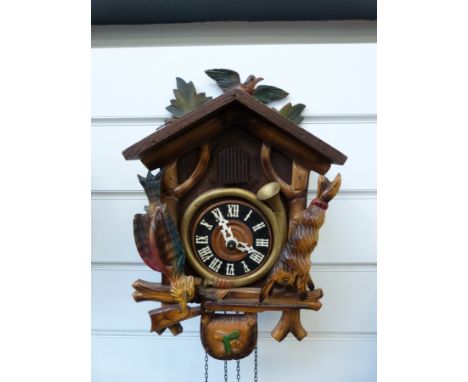 Two Black Forest cuckoo clocks, both with wooden reeds and cuckoo, one a "hunting" example