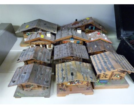 Eight chalet style musical boxes, two chalet style musical barometers, and a chalet style barometer 