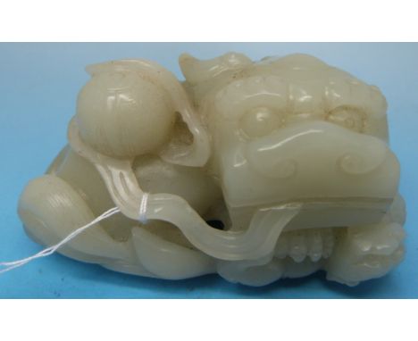 A Chinese carved celadon jade figure of a recumbent lion and cub with brocade ball atop (8.3cm wide)