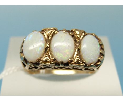 A 9ct gold ring set with three opals (size K)