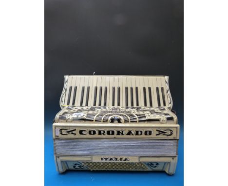 A Coronado 1930s 96 bass piano accordion, in ivory pearloid finish, black embellishment and diamanté decoration