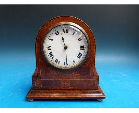 A small Edwardian arch top mantel timepiece in inlaid case with keyless Swiss movement by Buren, raised on brass feet