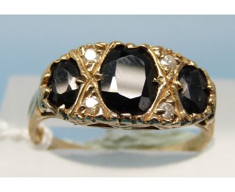 A 9ct gold ring set with three large oval sapphires with alternating diamonds (size N)