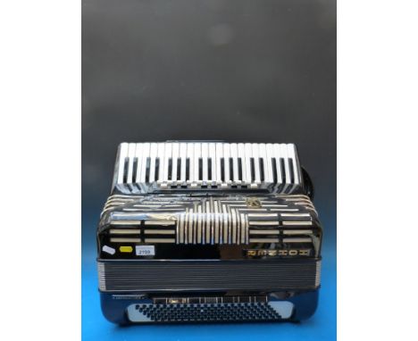 A Hohner Imperator V 120 bass five voice piano accordion, in gloss black finish (with case)