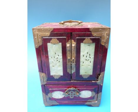 A Chinese brass-bound jade-inset table top jewellery cabinet, the eight jade panels all with carved decoration and the brass 