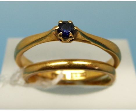 A 22ct gold wedding band (size K)and a 22ct gold ring set with a sapphire (size N)