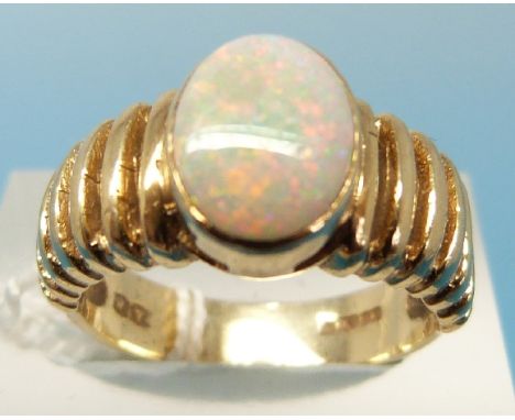 A 9ct gold ring set with an oval opal (size L)