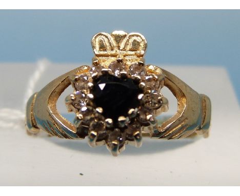 A 9ct gold ring set with a sapphire and diamonds in a heart shape (size M)