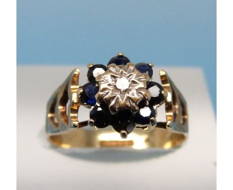 A 9ct gold ring set with a diamond surrounded by sapphires (size J)