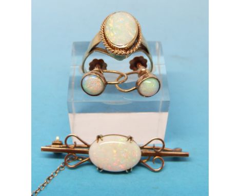 A yellow metal ring marked 9ct gold set with an oval opal, a yellow metal brooch marked 9ct set with an opal and matching ear