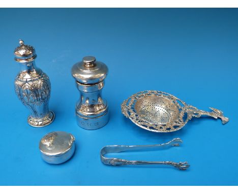 A German white metal tea strainer with eagle atop a column, together with a white metal pepper marked D&H sterling, trinket b
