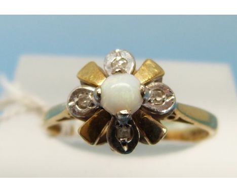 An 18ct gold ring set with a central opal and four diamonds in a flower cluster (size N)