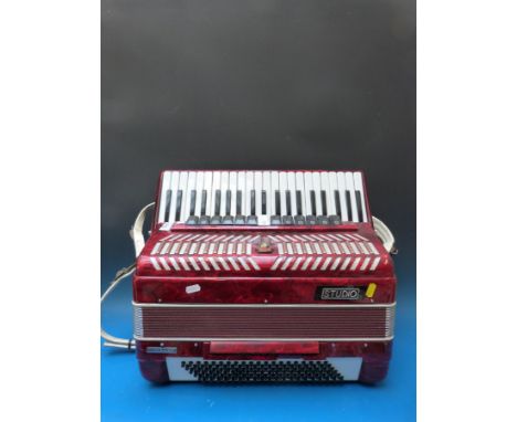 A Parrot 120 bass four voice c1990 piano accordion, in red pearloid finish (with case)