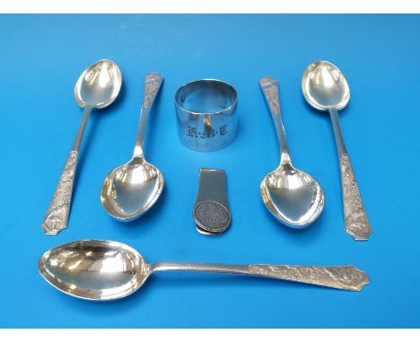 A set of five Chinese white metal spoons with birds in pine tree landscape decoration (weight 184g) together with a money cli