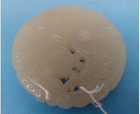 A finely carved Chinese white jade pendant in the form of a mythical beast (diameter 4.8cm)