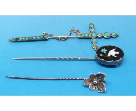 A stick pin marked 80 in the shape of a sword set with turquoise, a white metal stick pin decorated with pietra dura and a wh