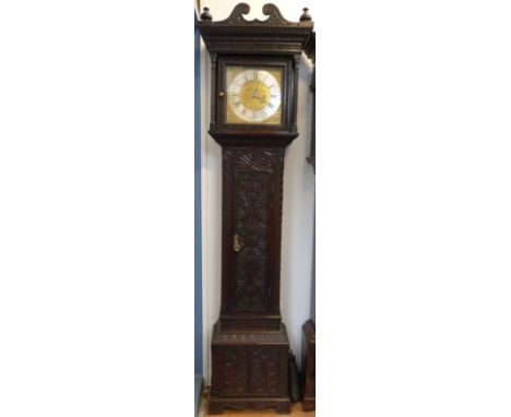 A late 18thC heavily carved long cased clock with a 30 hour movement, the brass dial with silvered chapter ring and date aper