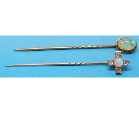 Two yellow metal stick pins one set with an opal and four diamonds in a cross shape and the other with an opal 