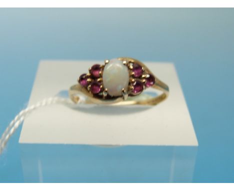 A 9ct gold ring set with an opal and rubies (size K)