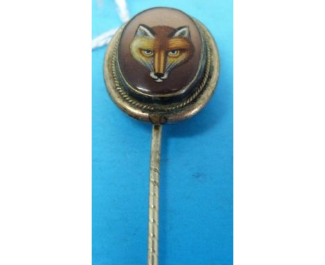 A 19thC stick pin set with a fox's head painted on glass with rope border 