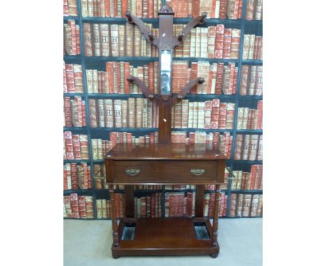 A late 19th/ early 20th century hall stand, with hanging pegs and mirror to top, the base having a fitted single drawer flank