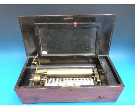A cylinder music box playing eight airs on a brass bed plate, thought to be manufactured by Bremond. Serial number 2402, inla