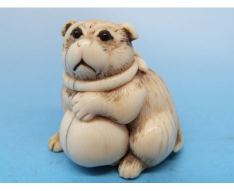 A 19thC Japanese netsuke of a pug and a ball