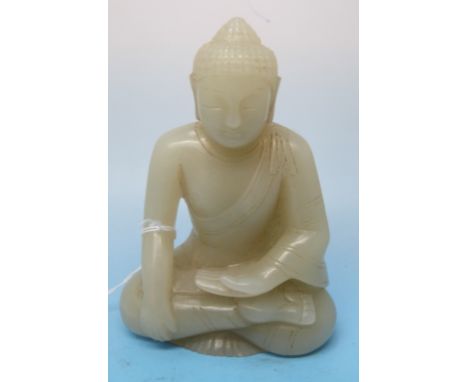 A pale celadon jade carving of a Buddha, intricately carved with serene expression (7.9cm)