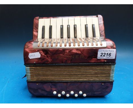 A Hohner 'Mignon' child's piano accordion in red pearloid finish 