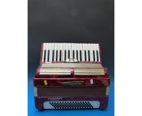 A German made Worldmaster Senola V 80 bass two voice piano accordion, in red pearloid finish (with case)
