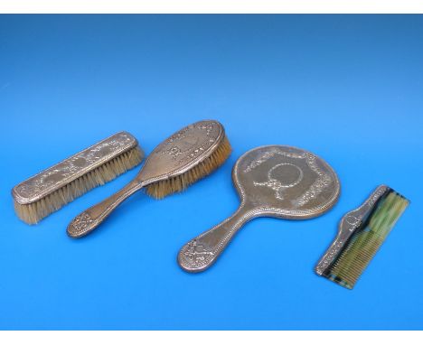 A four piece hallmarked silver mounted Neoclassical style dressing table set comprising hand mirror, two brushes and a comb